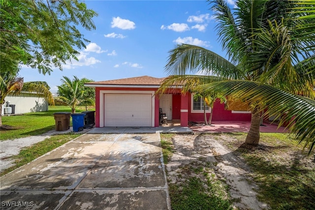 single story home with a garage and a front lawn