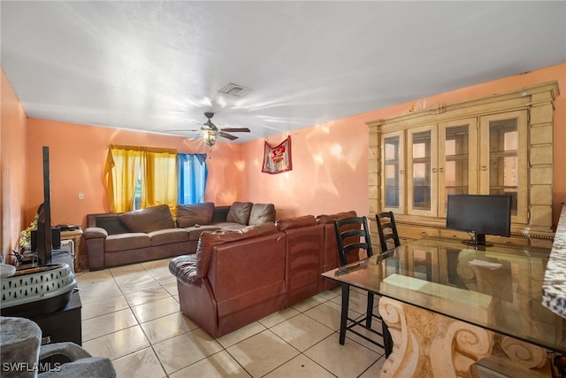 tiled living room with ceiling fan