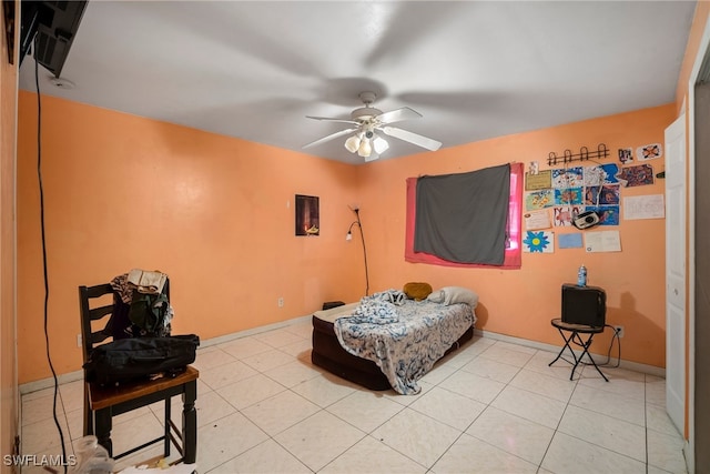 tiled bedroom featuring ceiling fan