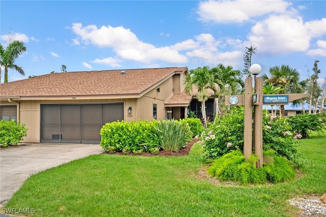 single story home with a front yard and a garage