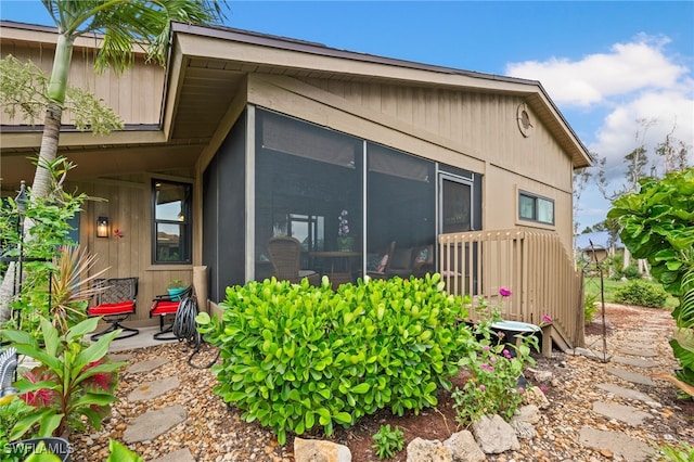 view of home's exterior with a sunroom