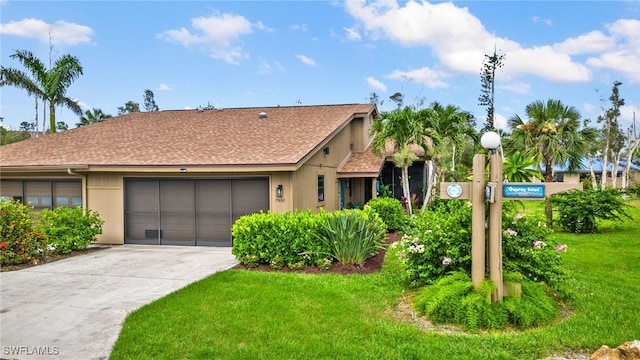 view of front of home featuring a garage and a front yard