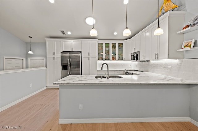 kitchen with light hardwood / wood-style floors, sink, white cabinetry, and stainless steel appliances