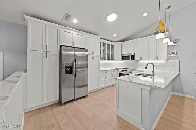 kitchen with sink, white cabinets, pendant lighting, and appliances with stainless steel finishes