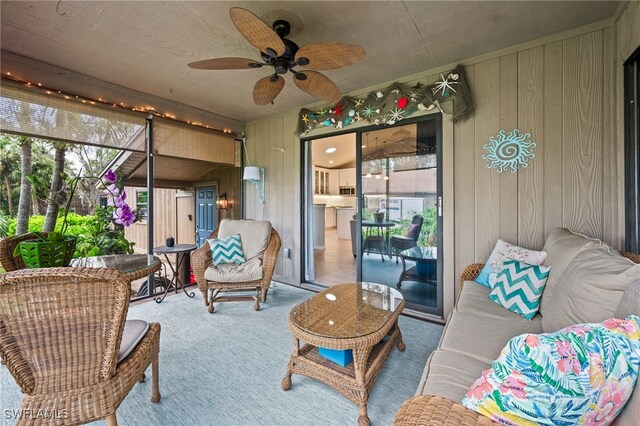 sunroom / solarium featuring plenty of natural light and ceiling fan