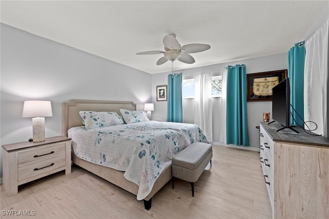 bedroom with ceiling fan and light hardwood / wood-style floors