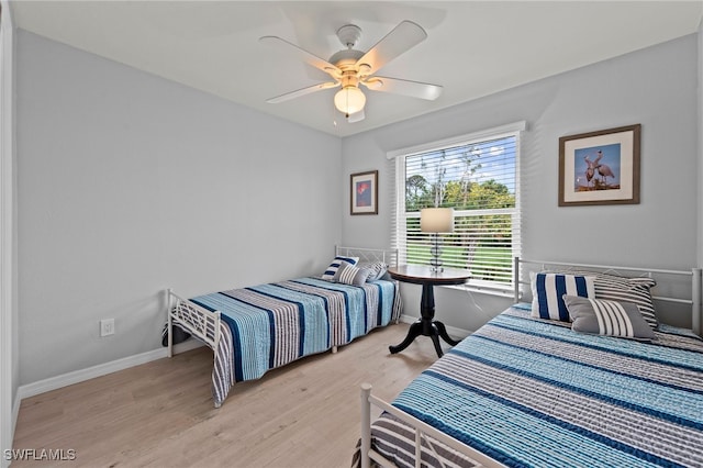 bedroom with ceiling fan and light wood-type flooring