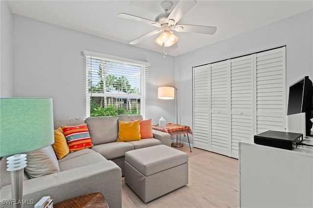 living room featuring ceiling fan and light hardwood / wood-style flooring