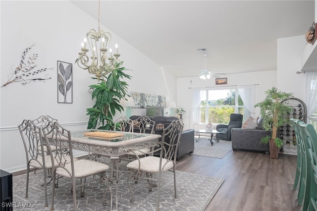 dining space with lofted ceiling, dark hardwood / wood-style floors, and ceiling fan with notable chandelier