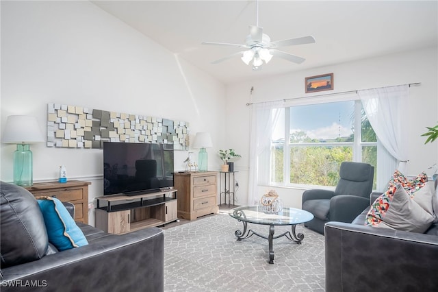 living room with ceiling fan and vaulted ceiling