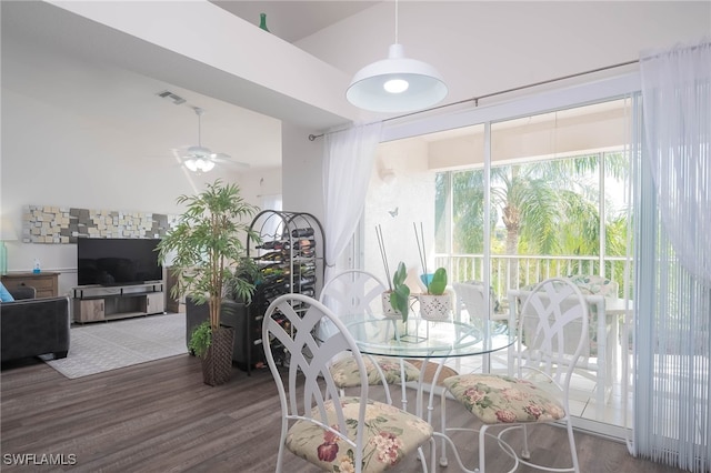 dining space with dark wood-type flooring and ceiling fan