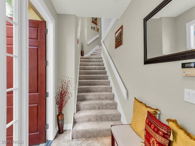 staircase with tile patterned floors