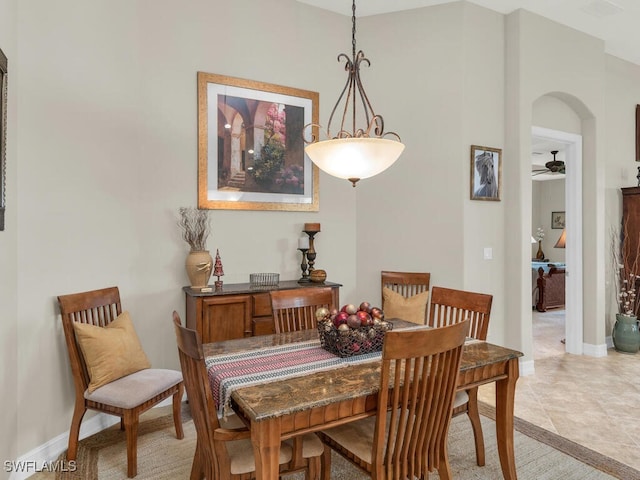 tiled dining room featuring ceiling fan