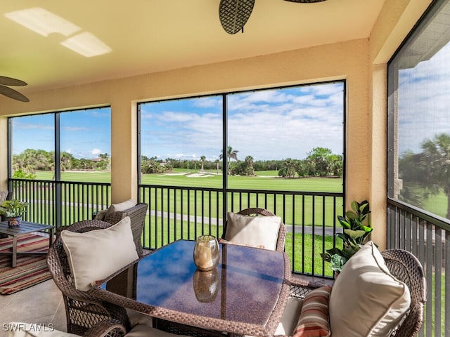 sunroom / solarium featuring ceiling fan