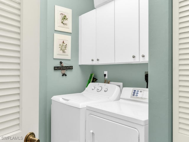 laundry room featuring cabinets and washing machine and dryer