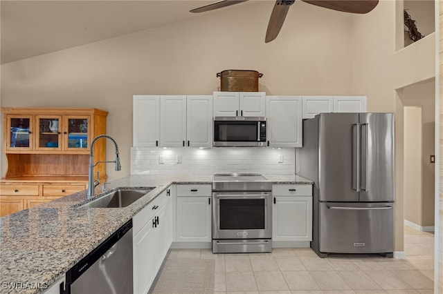 kitchen featuring white cabinets, appliances with stainless steel finishes, backsplash, and sink