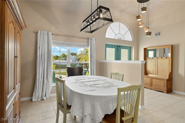 tiled dining room with a high ceiling