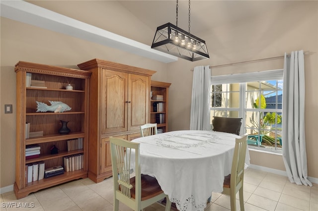 tiled dining space with lofted ceiling