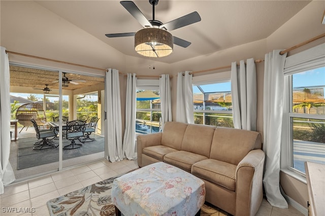 living room featuring light tile patterned floors, a wealth of natural light, and lofted ceiling