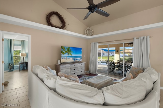 living room with ceiling fan, a healthy amount of sunlight, light tile patterned flooring, and high vaulted ceiling