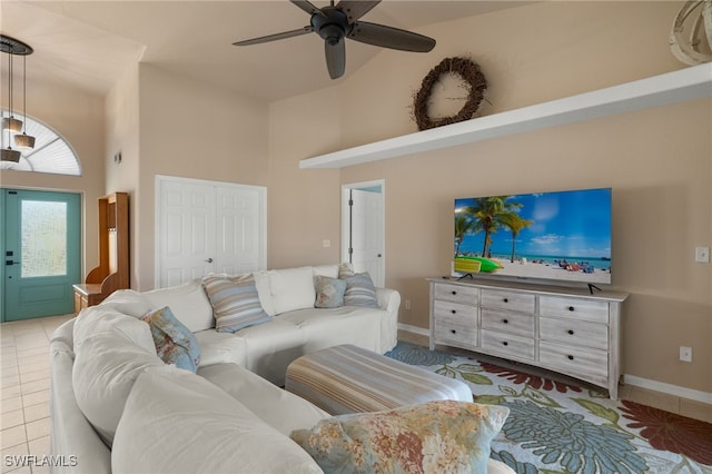 living room with light tile patterned floors, a towering ceiling, and ceiling fan