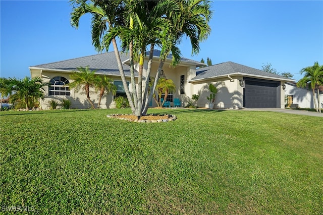 view of front facade featuring a front lawn and a garage