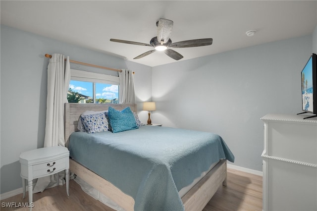 bedroom with ceiling fan and light wood-type flooring