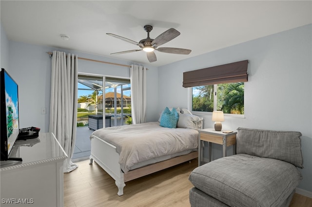 bedroom with ceiling fan, access to exterior, and light wood-type flooring