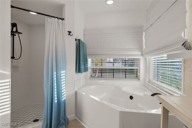 bathroom with shower with separate bathtub