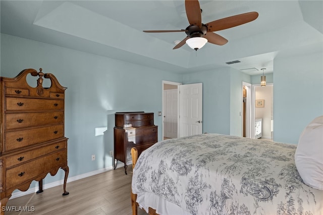 211 SW 21st Ln, Cape Coral, FL 33991 - bedroom with wood finished floors, a raised ceiling, baseboards, and a ceiling fan