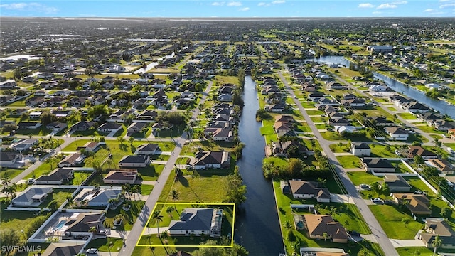 211 SW 21st Ln, Cape Coral, FL 33991 - aerial perspective of suburban area featuring property parcel outlined and a nearby body of water