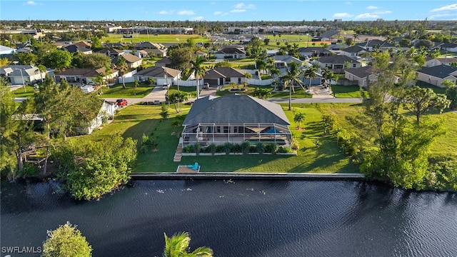 birds eye view of property with a water view and a residential view