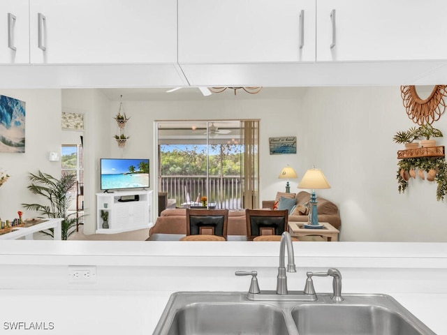 kitchen featuring white cabinetry and sink