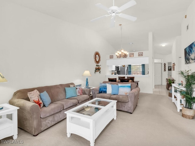 living room featuring high vaulted ceiling, light carpet, and ceiling fan with notable chandelier