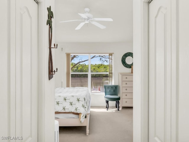 bedroom featuring light carpet and ceiling fan