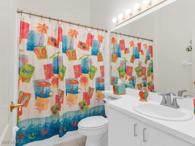 bathroom featuring toilet, vanity, tile patterned floors, and a shower with shower curtain