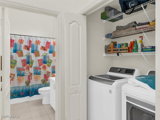 washroom with separate washer and dryer and light tile patterned floors