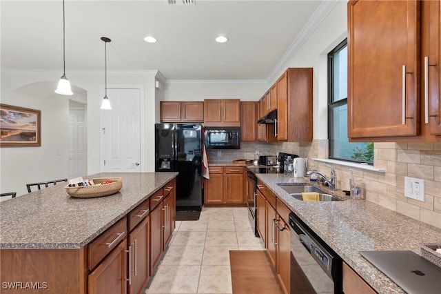 kitchen with a kitchen island, a sink, black appliances, brown cabinetry, and decorative light fixtures