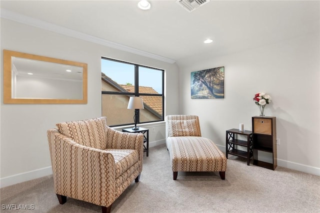 sitting room with carpet floors, baseboards, visible vents, and ornamental molding