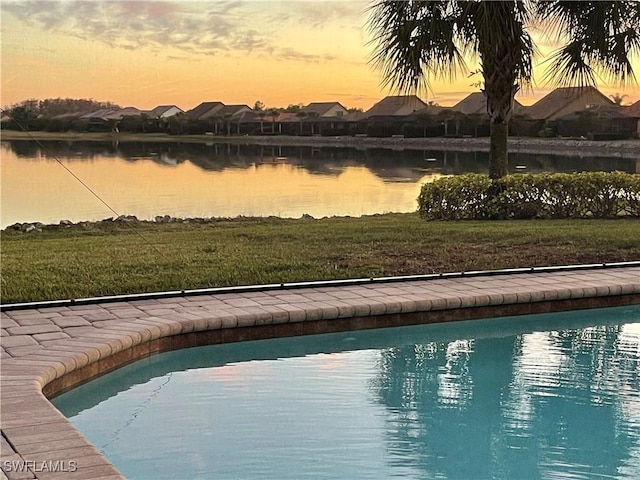 pool at dusk with a water view