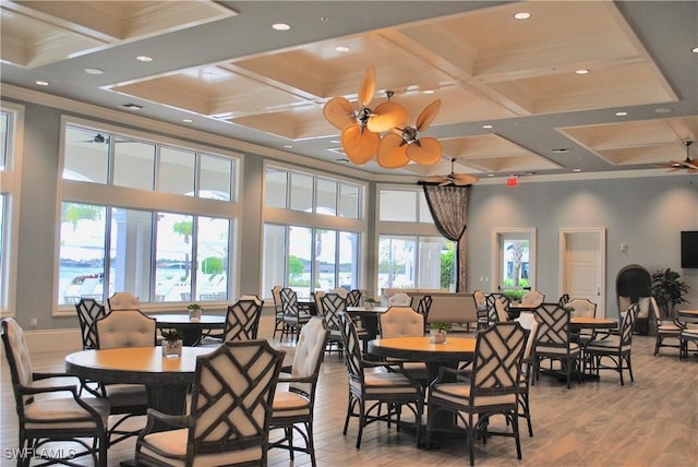 dining area with a towering ceiling, ceiling fan, and ornamental molding