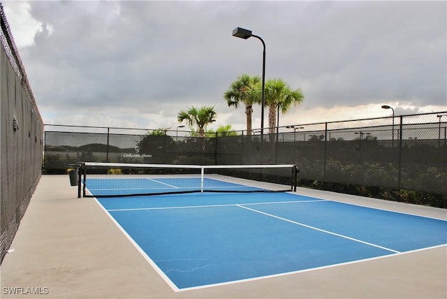 view of tennis court with fence