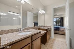 ensuite bathroom with tile patterned flooring, vanity, and ensuite bathroom