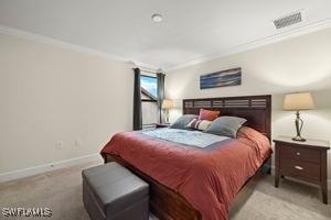 bedroom featuring visible vents, crown molding, light carpet, and baseboards