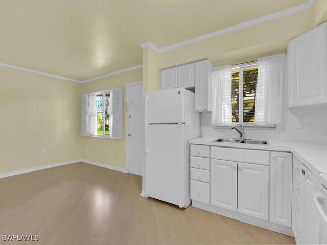 kitchen featuring white fridge, sink, decorative backsplash, light hardwood / wood-style floors, and white cabinets