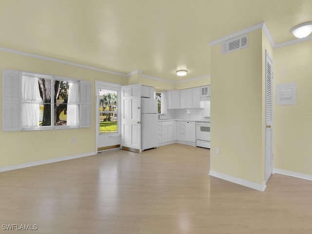 unfurnished living room with ornamental molding and light hardwood / wood-style flooring