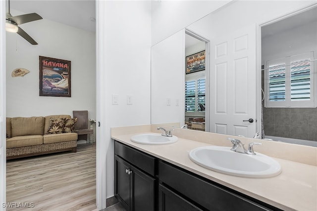 bathroom featuring plenty of natural light, ceiling fan, wood-type flooring, and vanity