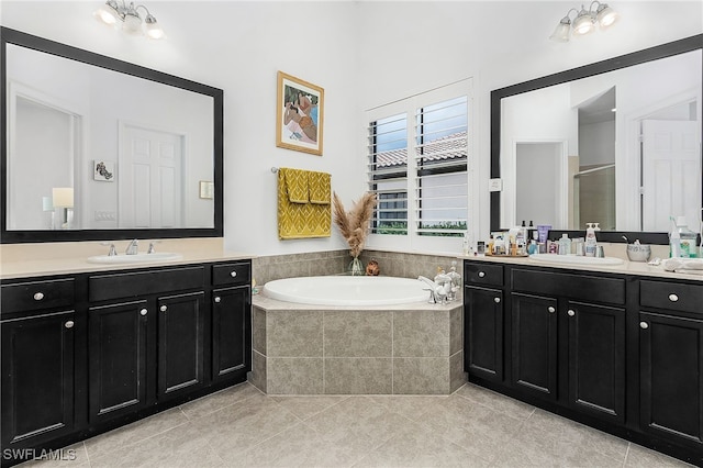 bathroom with plus walk in shower, tile patterned flooring, and vanity