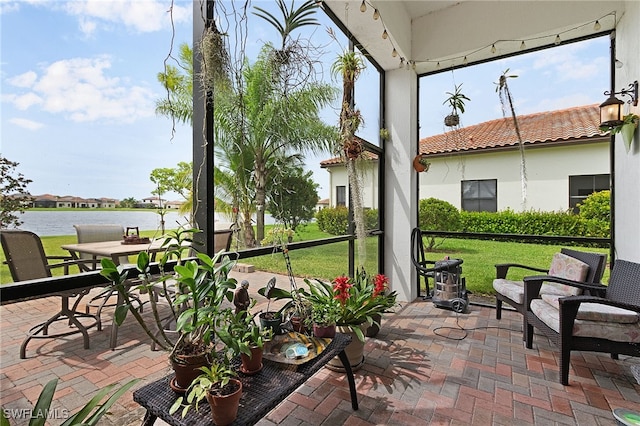 sunroom / solarium with a water view