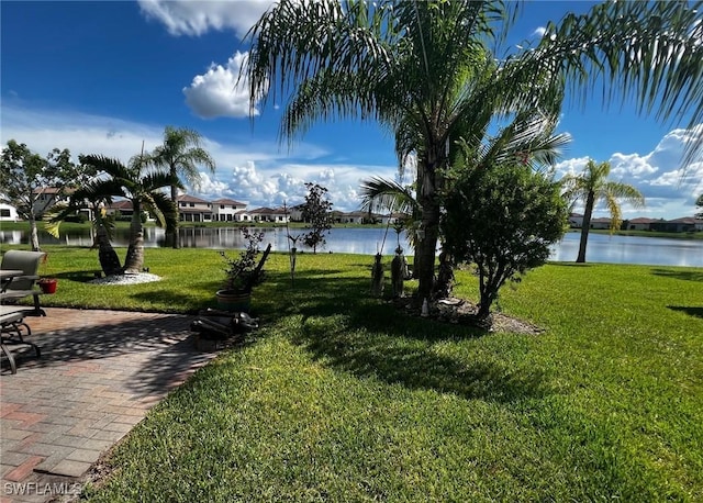 view of property's community featuring a lawn and a water view